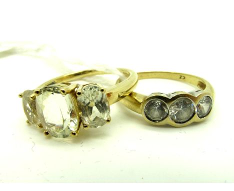 A 9ct Gold QVC Three Stone Dress Ring, graduated claw set; Together with Another, collet rubover set. (2) 