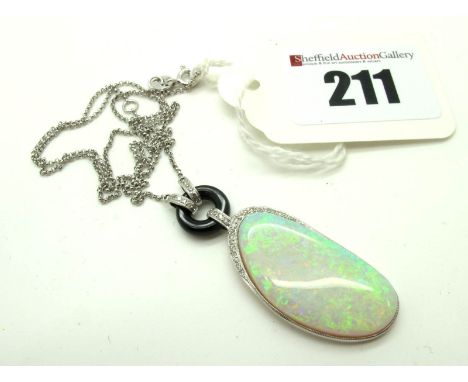 A Large Modern Opal and Diamond Set Pendant, stamped "12.25", on a fine link chain stamped "K18 750". 