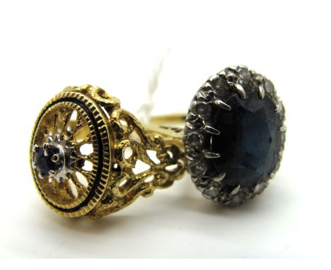 A Sapphire and Diamond Cluster Ring, oval claw set highlight, within claw set border between tapered shoulders; Together with