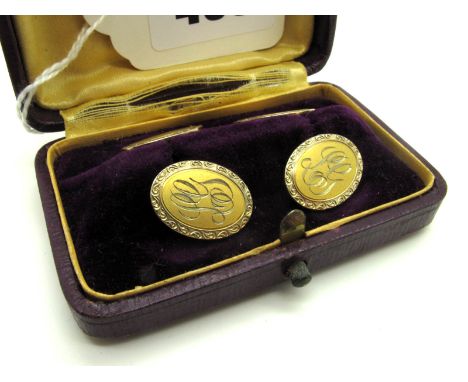 A Pair of Decorative Gent's Cufflinks, each with one oval panel initialled "LG", on bar connections stamped "Clark", in a fit