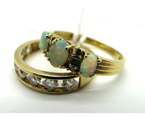 A 14ct Gold Dress Ring, channel set highlights; Together with An Opal Set Ring, claw set throughout. (2)