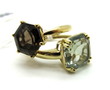 A 9ct Gold Smoky Quartz Dress Ring, of geometric design claw set between tapered shoulders; together with another 9ct gold ri