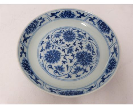 A Chinese blue and white porcelain saucer dish with foliate scroll and floral decoration, six-character Tongzhi mark. Diamete