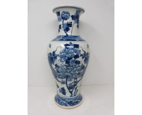 A Kangxi style blue and white baluster dragon vase with floral motifs. Four character mark to base. Height 38.5cm. 