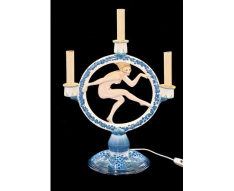 W. Tomasch for Goldscheider Austria, circa 1925 A Figural candlestick, later electrified,nude within a hoop decorated with st