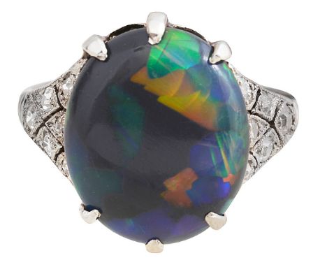 An Edwardian opal and diamond-set ringthe oval black opal cabochon claw-set about the openwork diaper work shoulders set with