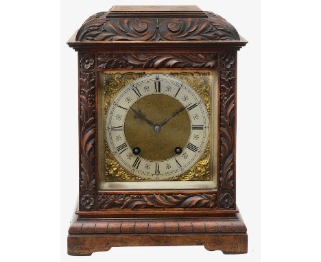 An early 20th century figured walnut cased mantel clockthe 5 3/4" square brass dial with silvered chapter ring with Roman num