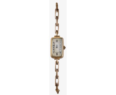 A 1920s lady's 9ct gold manual wind wristwatch rectangular silvered dial with black Roman numerals and minute track, winding 