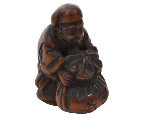 A Japanese Meiji period carved wood netsuke in the form of a man holding a large sack, craved signature height 4.2cm.Conditio