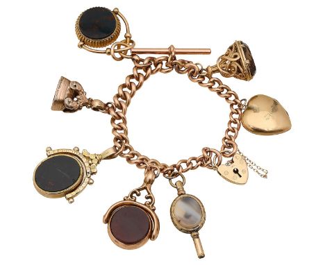 A 9ct gold charm braceletstamped to each link "9.375", with 9ct gold heart padlock clasp, suspending an assortment of charms 