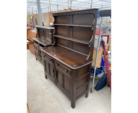 AN ERCOL ELM DRESSER WITH TWO DOORS, TWO DRAWERS AND UPPER PLATE RACK 