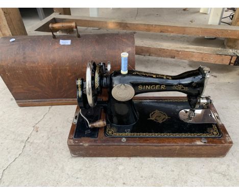 A CASED VINTAGE SINGER SEWING MACHINE WITH KEY 