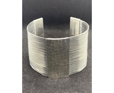 A HEAVY SILVER BANGLE 