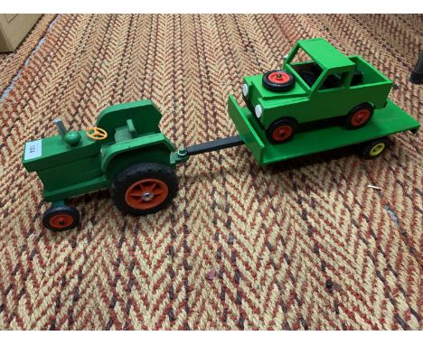 A WOODEN TRACTOR TOWING A WOODEN TRAILER WITH A LAND ROVER 