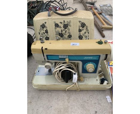 A VINTAGE CASED JONES 300 SEWING MACHINE 