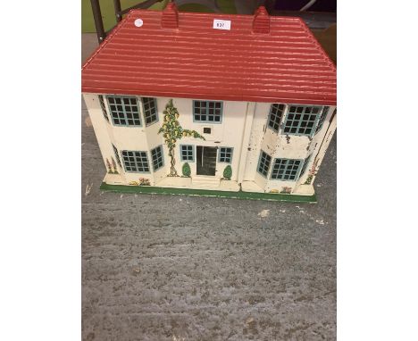 A VINTAGE 1950S DOLLS HOUSE WITH SLIDING METAL FRONTAGE 