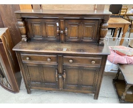 AN ERCOL COURT CUPBOARD ENCLOSING  CUPBOARDS AND DRAWERS, 48" WIDE 
