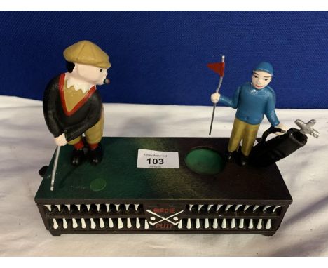 A CAST IRON MONEY BOX WITH A MOVABLE GOLFER AND CADDY 