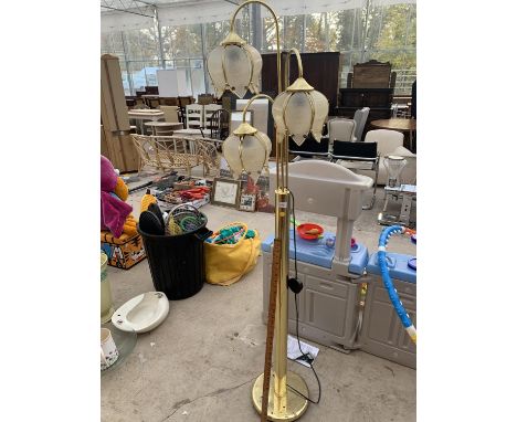 A BRASS THREE ARM FLOOR LAMP WITH GLASS FLOWER HEAD STYLE SHADES BELIEVED IN WORKING ORDER BUT NO WARRANTY 