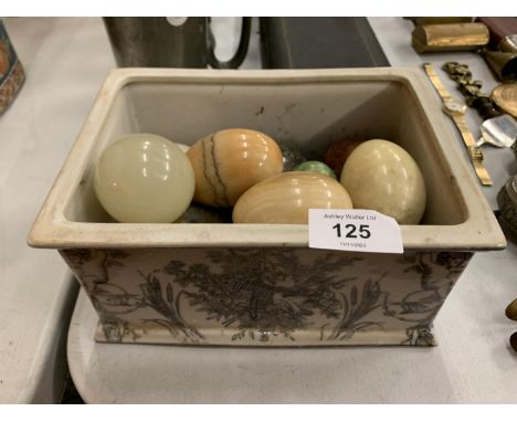 A CERAMIC BOX CONTAINING A QUANTITY OF MARBLE EGGS 