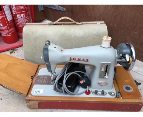 A VINTAGE JONES MODEL CBD CASED ELECTRIC SEWING MACHINE 