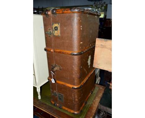 A VINTAGE TRAVELLING TRUNK WITH VARIOUS TRAVEL LABELS
