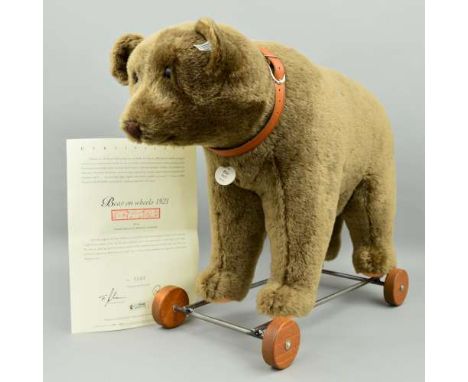 A BOXED LIMITED EDITION STEIFF 'BEAR ON WHEELS 1921', No.01002/1500, No.400384, on metal frame with wooden wheels and wearing