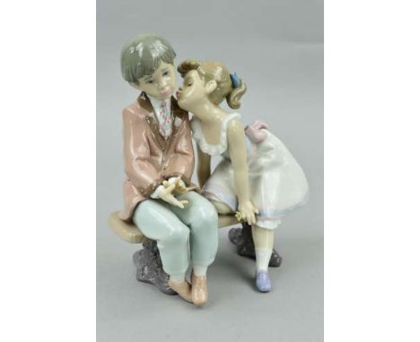 A BOXED LLADRO FIGURE GROUP, 'Ten and Growing' No 7635, depicting girl kissing boy on a bench, modelled by Francisco Polope, 