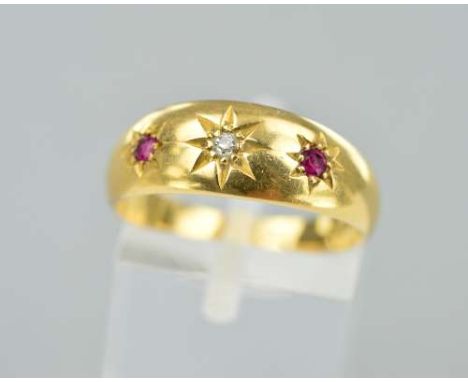 AN EARLY 20TH CENTURY 18CT GOLD RUBY AND DIAMOND RING, designed as a central diamond flanked by rubies, all within star setti