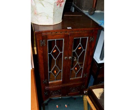 AN OLD CHARM OAK LEAD GLAZED TWO DOOR HI-FI CABINET, above double cupboard doors and a pair of speaker cabinets (3)  