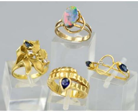 A MIXED GEMSTONE MODERN RING COLLECTION, to include a single stone pear shape sapphire rub over set coiled design, ring size 