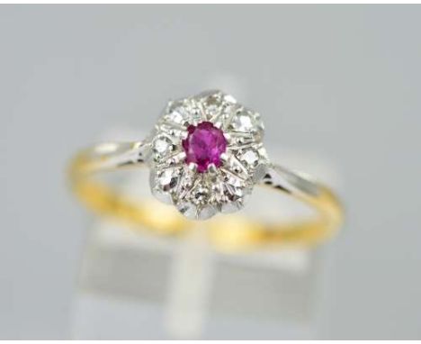 A DIAMOND AND RUBY CLUSTER RING, designed as four diamonds surrounding one central claw set synthetic ruby on a cathedral set