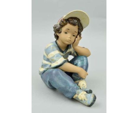 A BOXED LLADRO GRES FIGURE, 'Long Day' No 2209, depicting young boy sat looking fed up, approximate height 19.5cm (slight scr