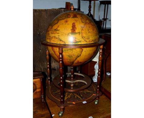 A REPRODUCTION DRINKS GLOBE, with an undertier on casters 