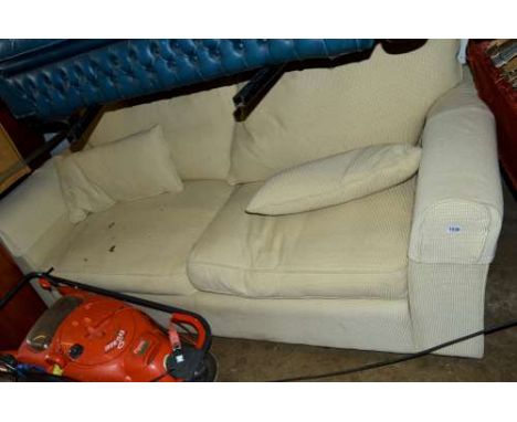 A LARGE UPHOLSTERED TWO SEATER SOFA