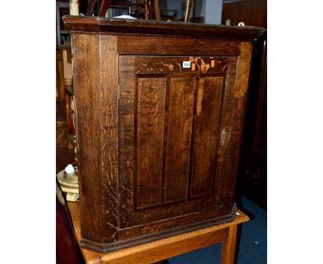 AN EARLY 20TH CENTURY OAK PANELLED SINGLE DOOR CORNER CUPBOARD (key), together with an Edwardian mahogany elbow chair, three 