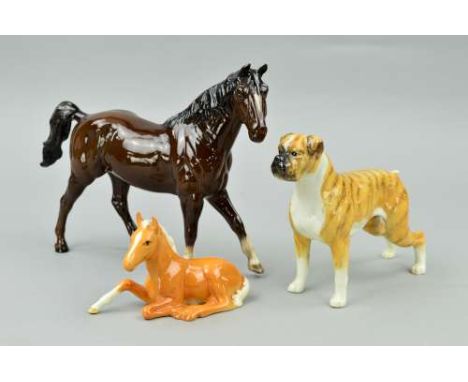 A BESWICK BOXER DOG 'BLUE MOUNTAIN GRETA' No 1202, a Beswick foal (lying) No915, palomino and a Royal Doulton 'Quarter Horse'