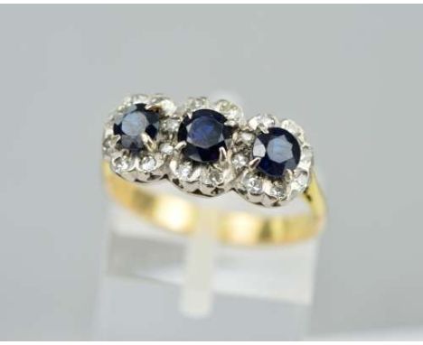 A SAPPHIRE AND DIAMOND DRESS RING, designed as three circular sapphires within single cut diamond surrounds, approximate leng