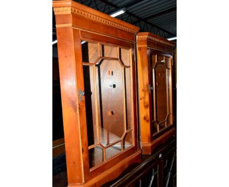 TWO MODERN YEW WOOD GLAZED CORNER CUPBOARDS, a matching hi-fi cabinet and a modern cheval mirror (4)