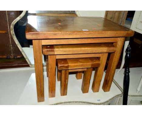 A LIGHT OAK NEST OF THREE TABLES