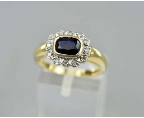 A 9CT GOLD SAPPHIRE AND DIAMOND RING, the rectangular sapphire within a collet setting to the single cut diamond surround, ha