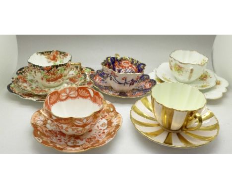 A collection of cups and saucers and trios, including Foley, Wileman, Shelley and Chapman, with stands