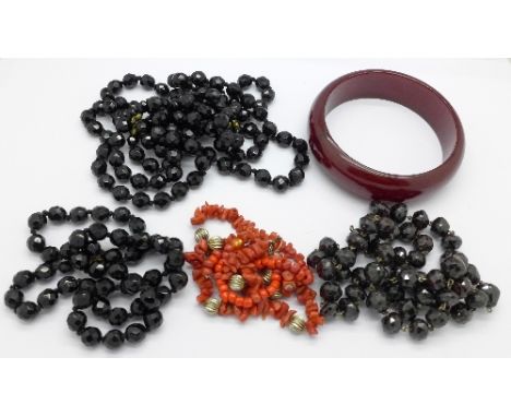 A coral necklet, three other necklets and a bangle