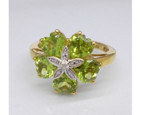 A silver gilt, peridot and diamond ring, R