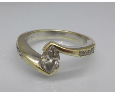 A yellow metal ring set with marquis diamond and four diamonds on each shoulder, marquis diamond over 0.5 carat weight, 5.4g,