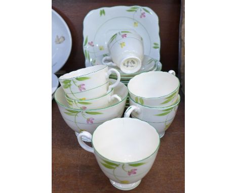 A Delphine china tea service, one cake plate, six side plates, six saucers, five cups, sugar and cream