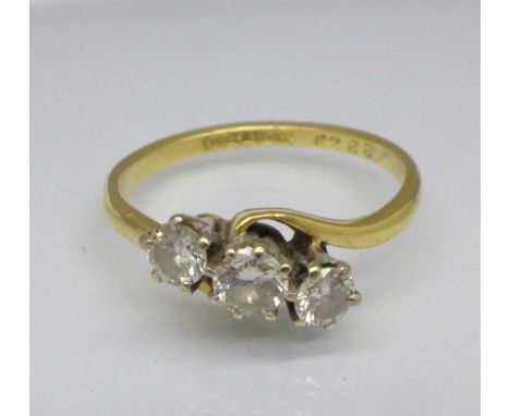 An 18ct gold and three stone diamond ring, 2.9g, O