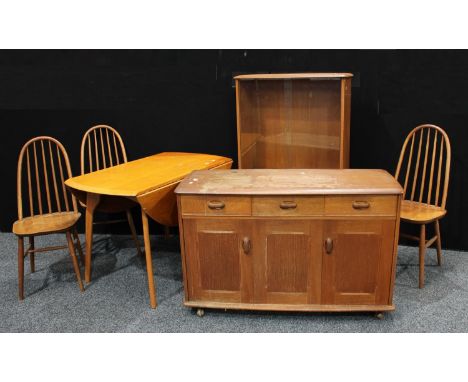 A 1950s Ercol Elm circular dropleaf dining table, 112cm diameter, pair of tall back Windsor chairs; similar sideboard, of thr