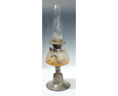 An early 20th century oil lamp, persian style white metal base 