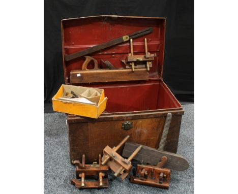 A large collection of wood planes and tools, contained in tin trunk 